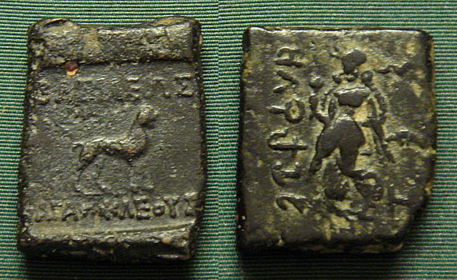 Indian coinage of Agathocles, with Buddhist lion and dancing woman holding lotus, possible Indian goddess Lakshmi.