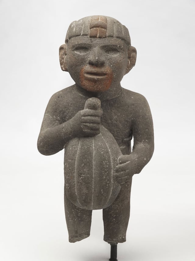 Aztec. Man Carrying a Cacao Pod, 1440–1521. Volcanic stone, traces of red pigment. Brooklyn Museum