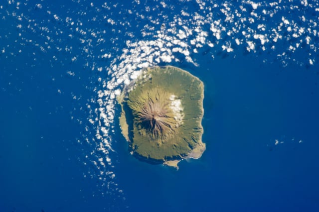 Tristan da Cunha on 6 February 2013, as seen from space. The population was temporarily evacuated to the UK in 1961 because of an eruption. Postal code TDCU 1ZZ