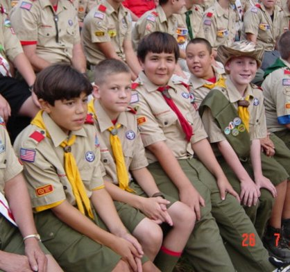 Scouts at a campfire ring at summer camp.