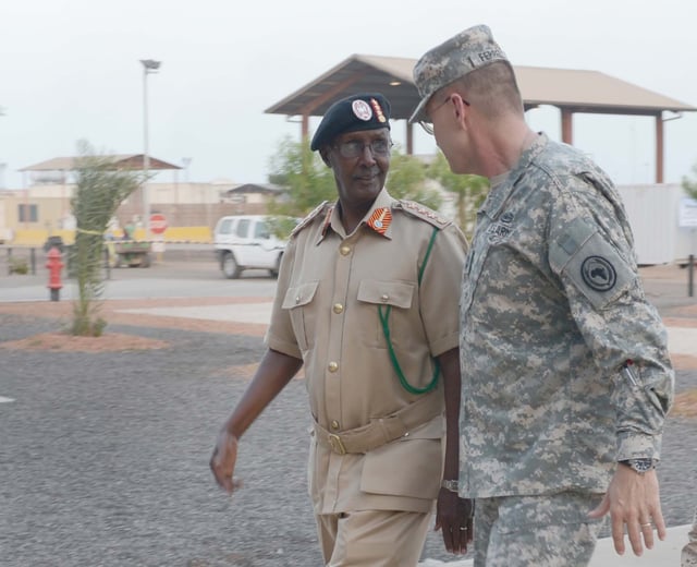 Maj. Gen. Terry Ferrell, Commander of the Combined Joint Task Force-Horn of Africa, and Gen. Dahir Adan Elmi, Chief of Defense for the Somali Armed Forces, walk together into the galley at Camp Lemonnier, Djibouti (May 2013).