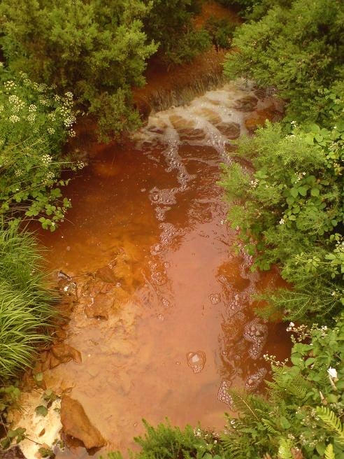 Acid mine drainage affecting the stream running from the disused Parys Mountain copper mines