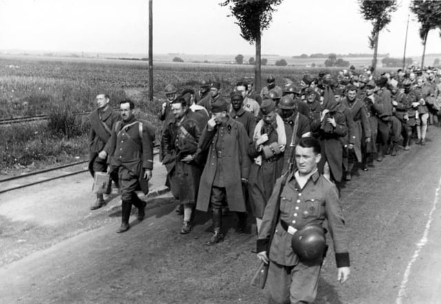 French prisoners of war are marched off under German guard, 1940