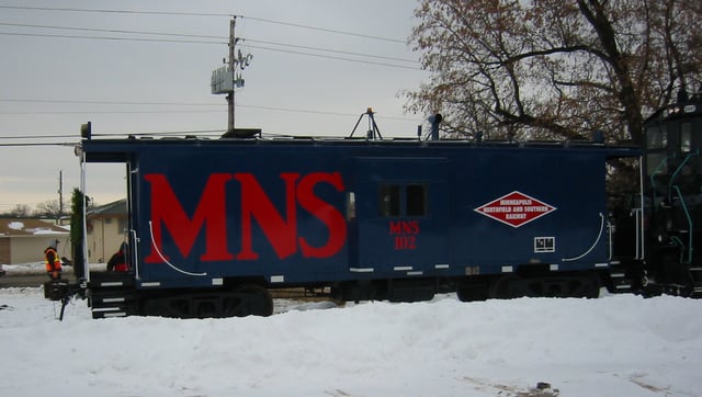 A caboose painted in the former Minneapolis, Northfield and Southern livery. This caboose is now in regular service on the Progressive Rail line in Bloomington, Minnesota.