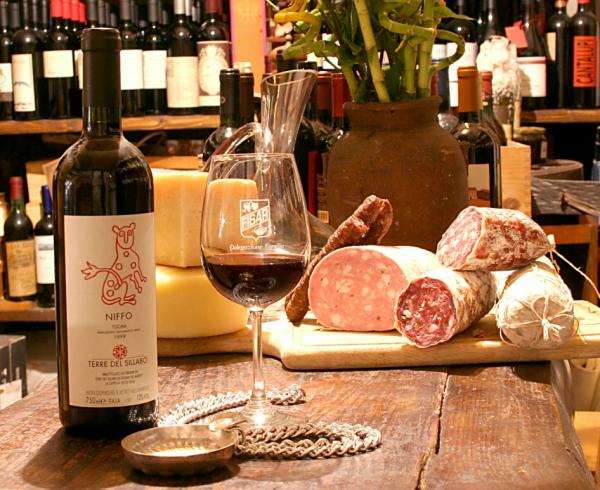 An assortment of Tuscan foods (from Lucca): various wine and cheese, and different sorts of salamis and hams