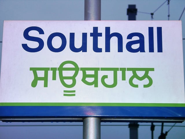 Station sign in the Latin and Gurmukhī scripts in Southall, UK