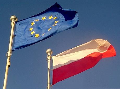 Flags of Poland and the European Union. The country became a member of the European community of nations on 1 May 2004.