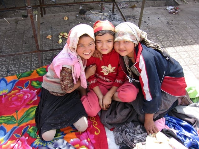 Three Uyghur girls at a Sunday market in the oasis city Khotan