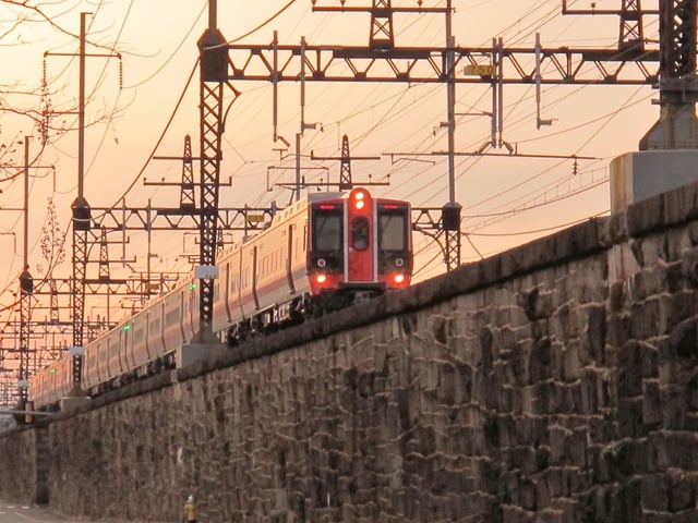 A New Haven Line train approaches the intermodal transit hub at Bridgeport Station