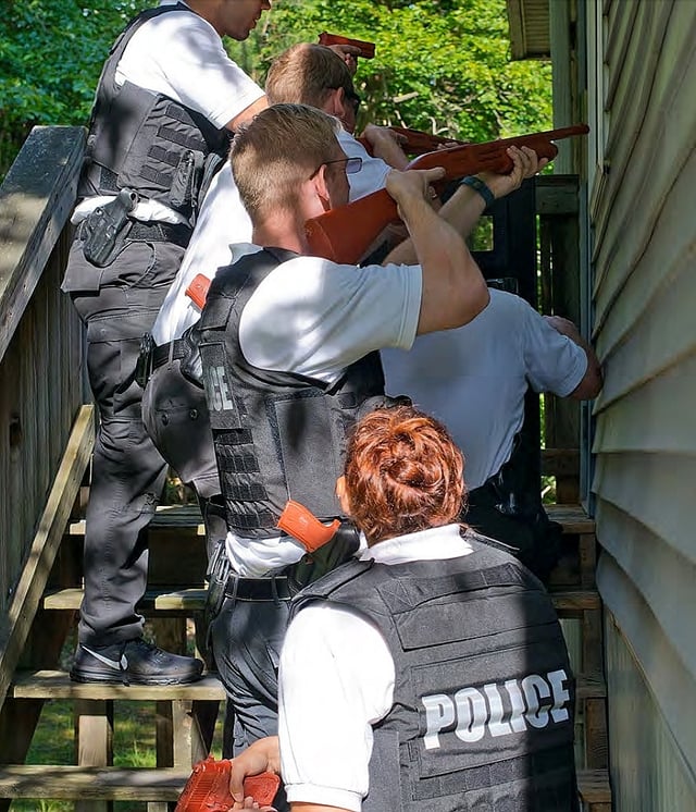 Secret Service agent trainees practice executing a search warrant.