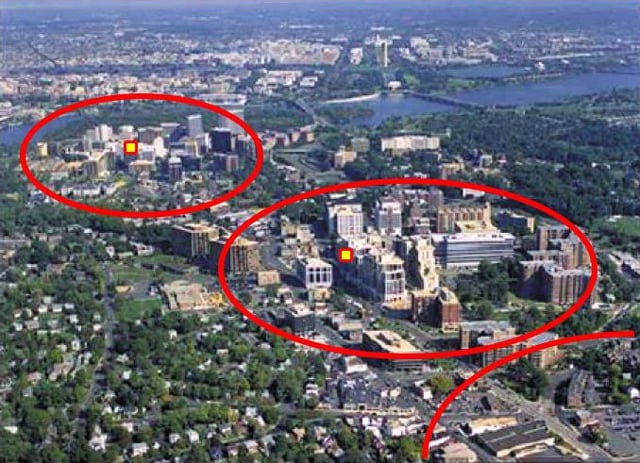 Aerial view of a growth pattern in Arlington County, Virginia. High density, mixed-use development is often concentrated within 1/4 to 1/2 mile from the County's Metrorail rapid transit stations, such as in Rosslyn, Courthouse, and Clarendon (shown in red from upper left to lower right).