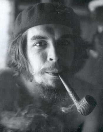 Smoking a pipe at his guerrilla base in the Escambray Mountains