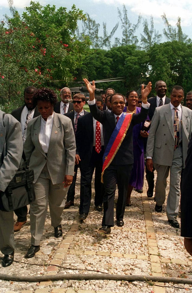 Jean-Bertrand Aristide returns to Haiti, following the U.S.-led invasion in 1994 designed to remove the regime installed by the 1991 Haitian coup d'état