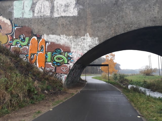 Throw-ups and a piece under a railway bridge in Poland.
