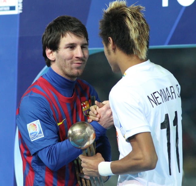 Messi accepting the Golden Ball award, alongside his future teammate Neymar after the 2011 FIFA Club World Cup Final