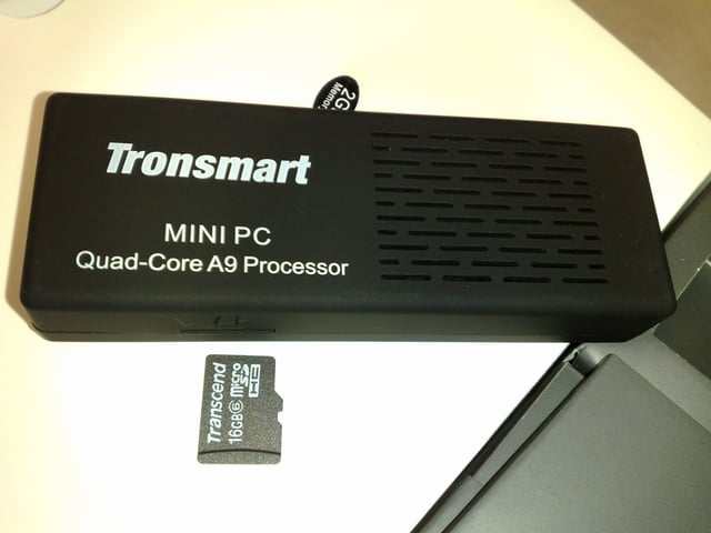Tronsmart MK908, a Rockchip-based quad-core Android "mini PC", with a microSD card next to it for a size comparison