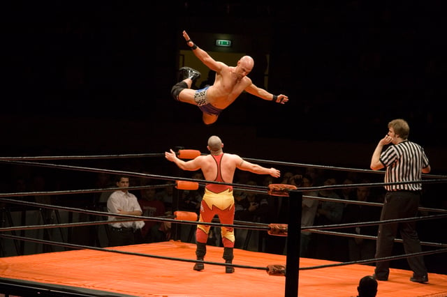 A wrestler (Christopher Daniels) leaps off the top rope