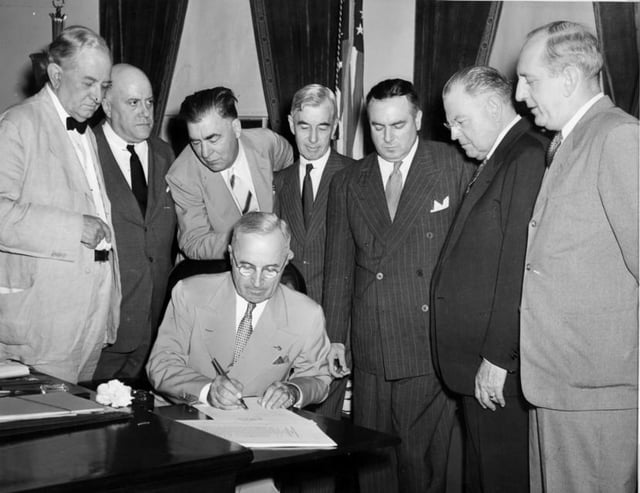 President Harry S. Truman signs the Atomic Energy Act of 1946, establishing the United States Atomic Energy Commission.