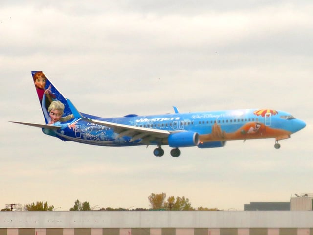An advertisement for the film on a WestJet Boeing 737-8CT at John F. Kennedy International Airport.