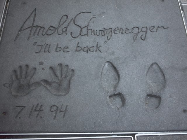 Footprints and handprints of Arnold Schwarzenegger in front of the Grauman's Chinese Theatre, with his catchphrase "I'll be back" written in.