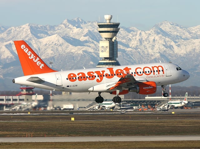 EasyJet Airbus A319 landing at Malpensa with the Alps visible in the background