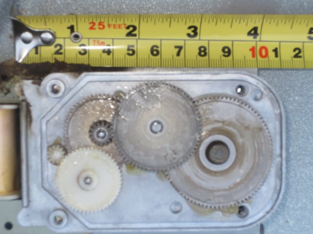 Multiple reducer gears in microwave oven (ruler for scale)