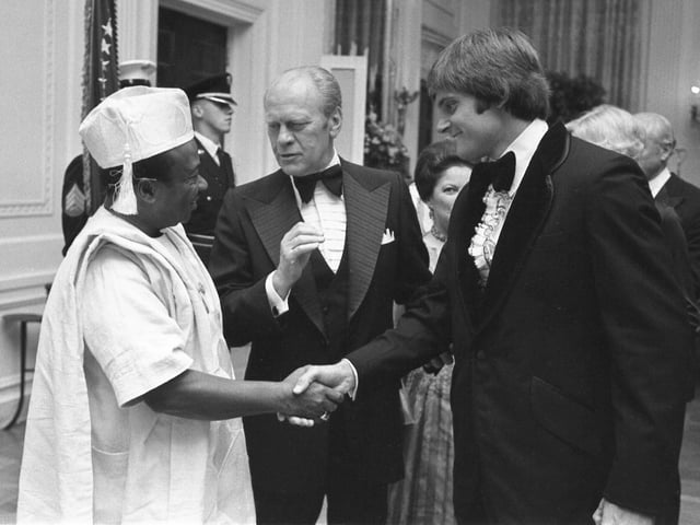 Jenner (right) greets Liberian president William Tolbert (left) at the White House on September 21, 1976, as United States President Gerald Ford looks on