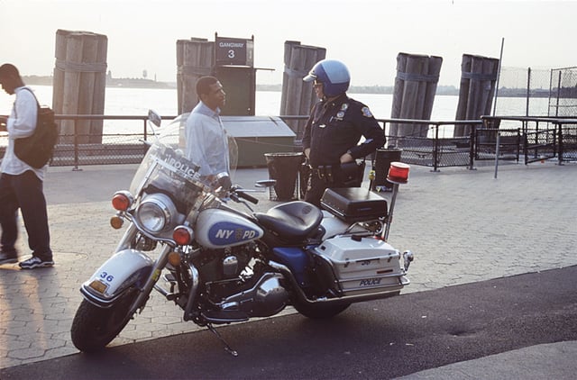 Motorcycle police officer speaks with a passerby