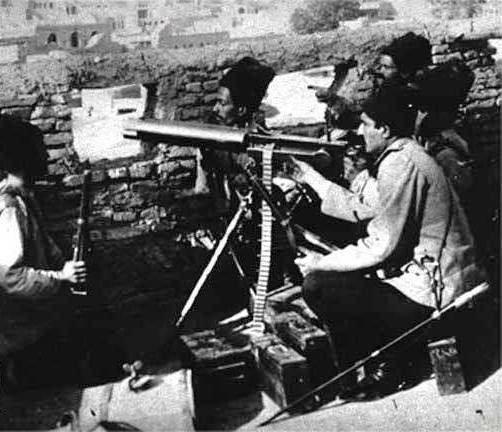 Reza Pahlavi behind a machine gun