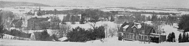 Panoramic view of campus, 1916; in the foreground at the left is the Apiary Laboratory, Fernald Hall, the Old Chapel, and Clark Hall, in the distance to the right can be seen French Hall and Stockbridge Hall