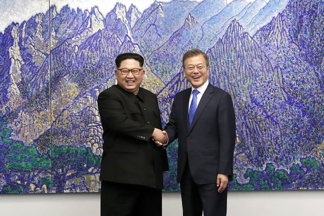 Kim and South Korean President Moon Jae-in shake hands during the 2018 inter-Korean Summit, April 2018