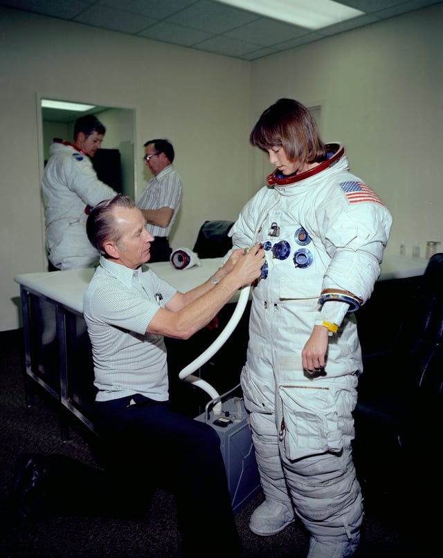 Fisher being suited up. As one of the first woman astronauts, she contributed to the design of a space suit tailored to the female anatomy.