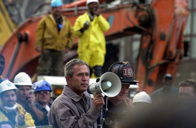President Bush, standing with firefighter Bob Beckwith, addressing rescue workers at Ground Zero in New York, September 14, 2001