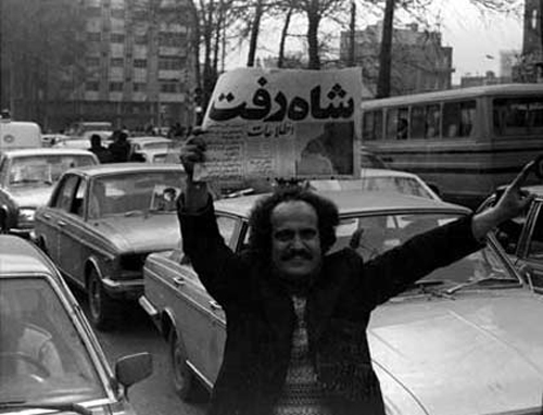 Ettela'at newspaper in the hand of a revolutionary when Mohammad Reza and his family left Iran on January 16, 1979: "The Shah is Gone".