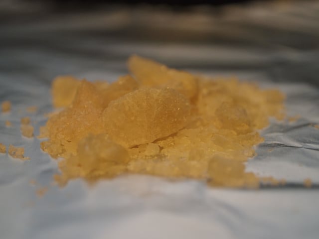 A salt of MDMA (typically white) with impurities, resulting in a tan discoloration