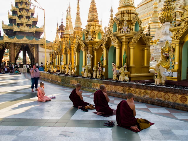 Praying Buddhist monks in Shwedagon Pagoda