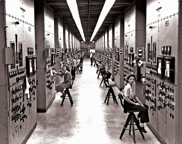 Calutron Girls were young women who monitored calutron control panels at Y-12. Gladys Owens, seated in the foreground, was unaware of what she had been involved with until seeing this photo on a public tour of the facility 50 years later.  Photo by Ed Westcott.