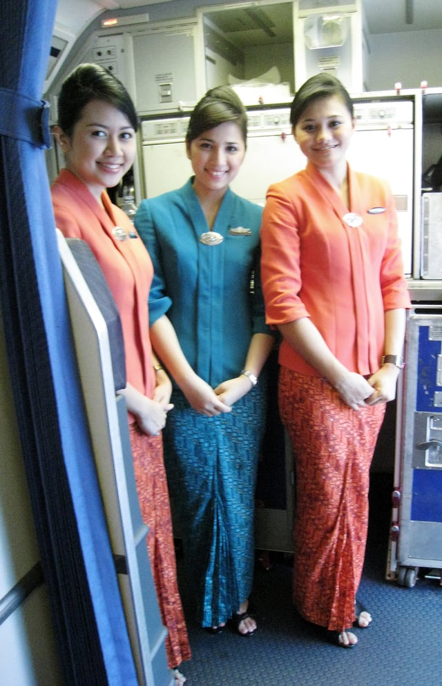 Garuda Indonesia flight attendants in uniform featuring kebaya.