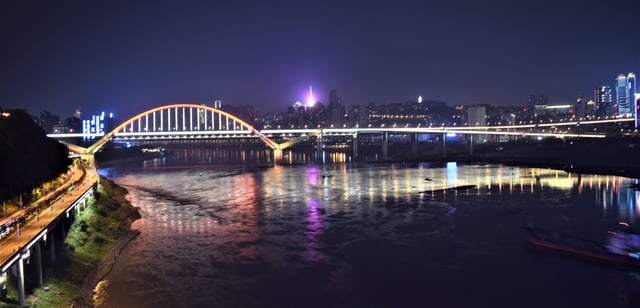 Night view of Caiyuanba bridge across Yangtze river in Chongqing