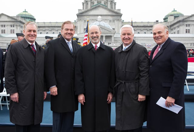 Five governors of the Commonwealth of Pennsylvania who  have served since 1995, (left to right): Mark Schweiker, Tom Ridge, Tom Wolf, Tom Corbett and Ed Rendell (January 2015), pose in front of the south facade of the Pennsylvania State Capitol on the Susquehanna River front in Harrisburg at a gubernatorial inauguration