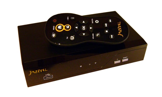 Some VOD services require the viewer to have a TV set-top box. This photo shows the set-top box for the Jazzbox VOD service and its accompanying remote control.
