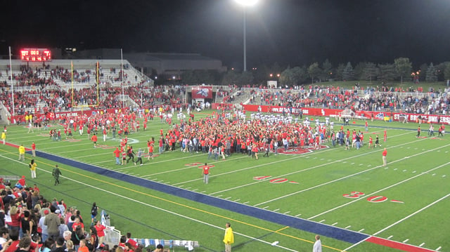 Stony Brook fans rush the field after a memorable comeback over the Colgate Raiders for a seventh straight Homecoming victory.