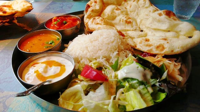 Vegetarian thali with naan, daal, raita and papad