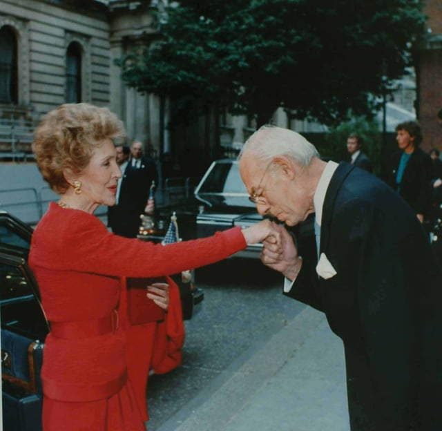 Denis Thatcher, husband of Margaret Thatcher, kissing the hand of Nancy Reagan wife of Former US President in 1988