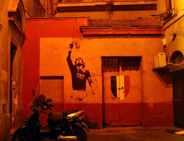 Decal of Totti alongside the Scudetto shield, displayed on a house in Rome