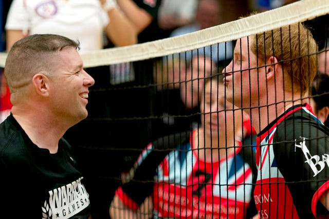 Harry (right) talking to an opponent during a volleyball competition between American and British injured soldiers, 13 May 2013