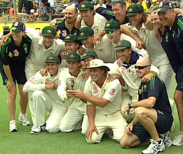 The Australian cricket team celebrate, with the new replica of The Ashes urn