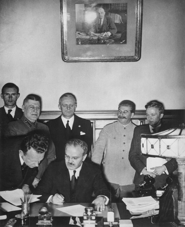 Vyacheslav Molotov signs the Molotov–Ribbentrop Pact, a German–Soviet non-aggression pact.