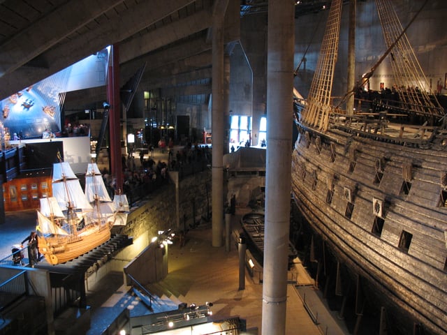 The main hall of the Vasa Museum with a scale model of Vasa as it might have looked on its maiden voyage to the left and the preserved ship itself to the right