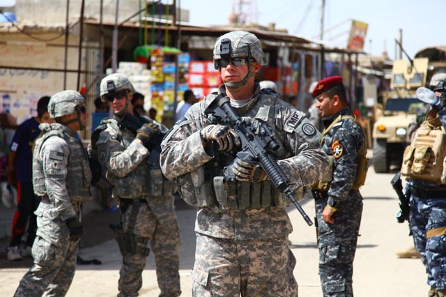 Alabama Army National Guard MP, MSG Schur, during a joint community policing patrol in Basra, 3 April 2010